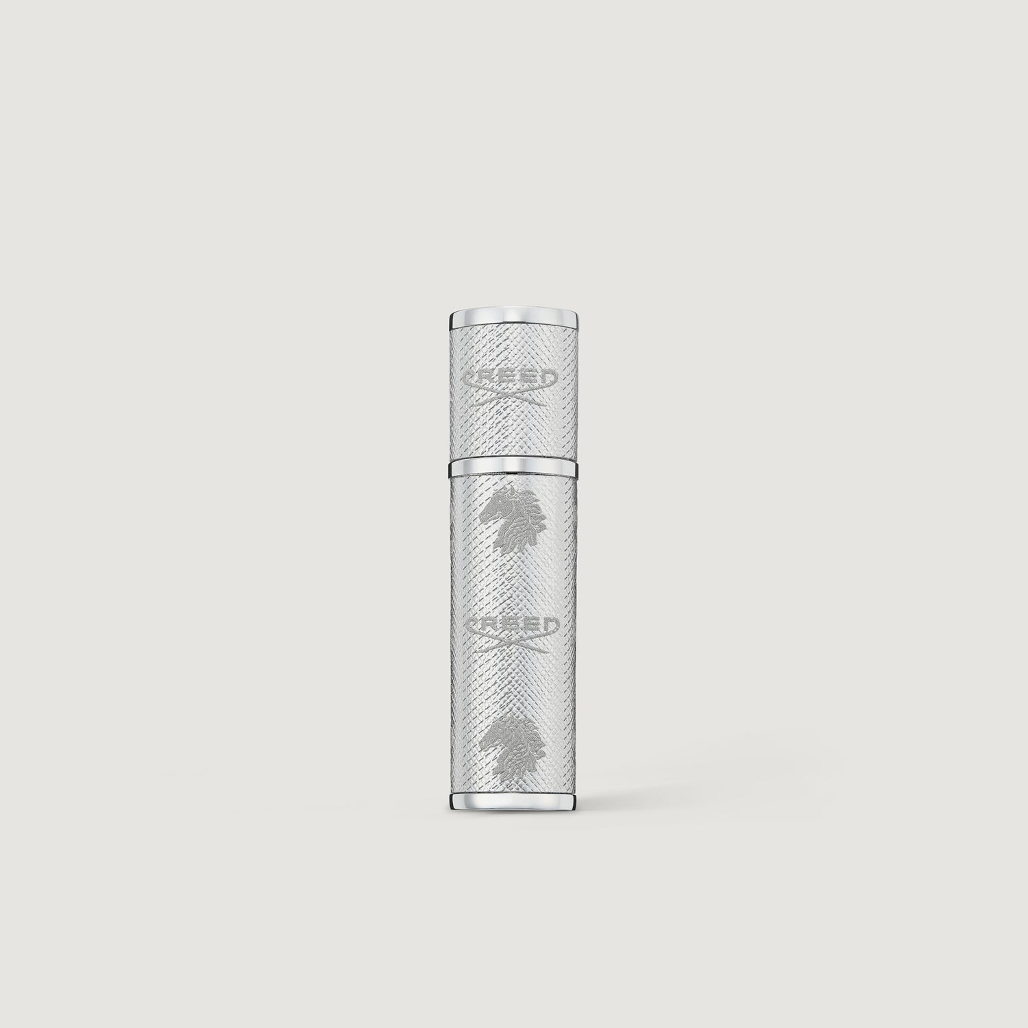 Creed silver leather 5ml perfume atomizer on a light gray background