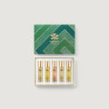 Set of Creed perfume bottles in a decorative box on a light gray background