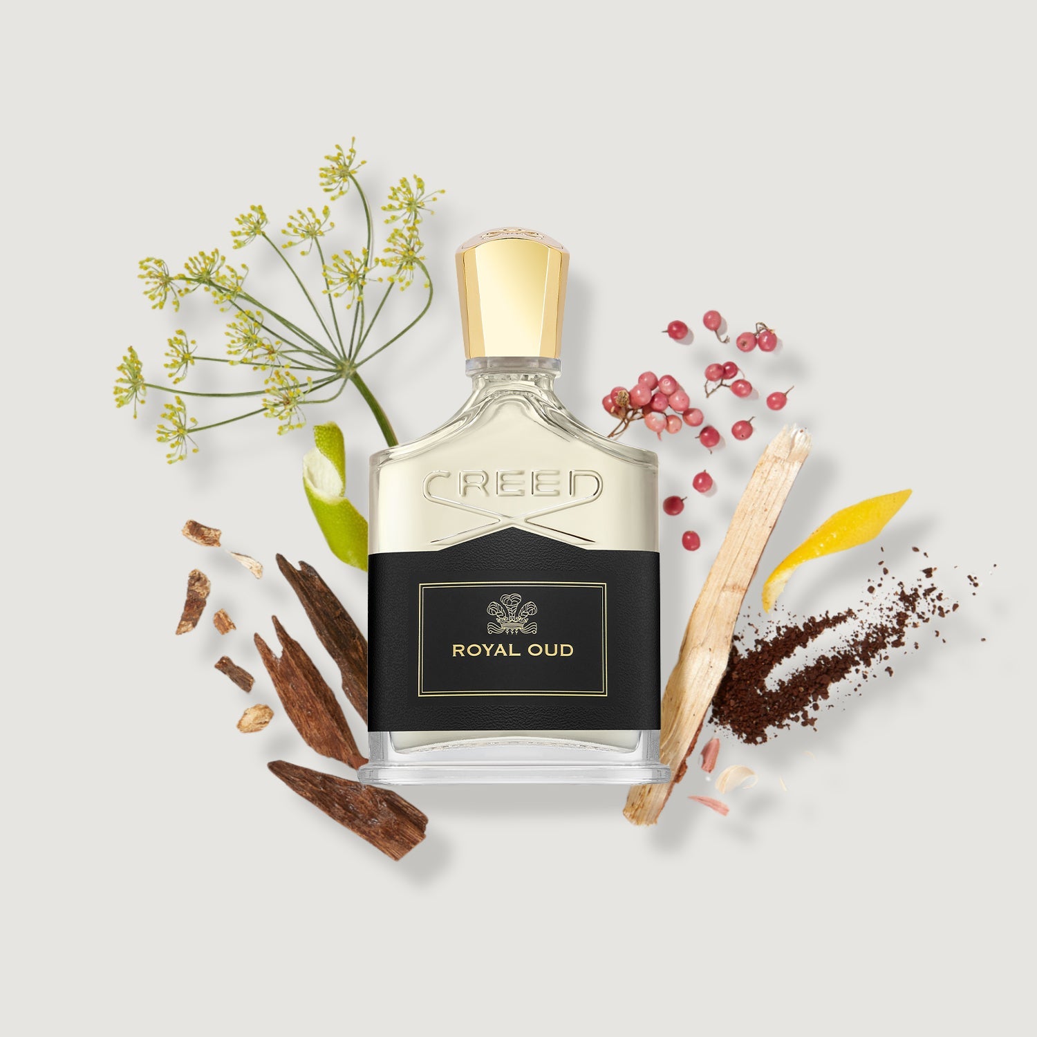 Creed Royal Oud perfume bottle with botanical elements on a light background