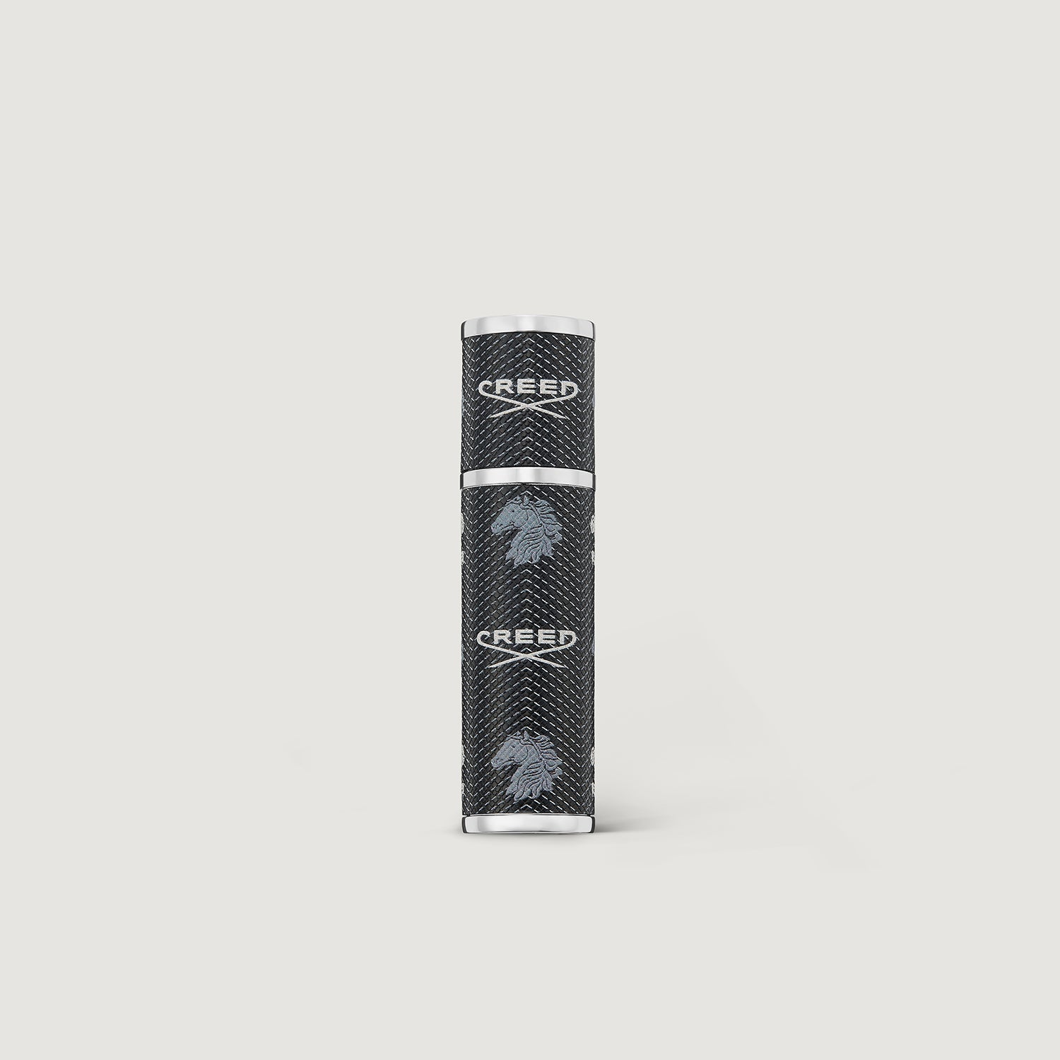Black and silver cylindrical product on a light gray background